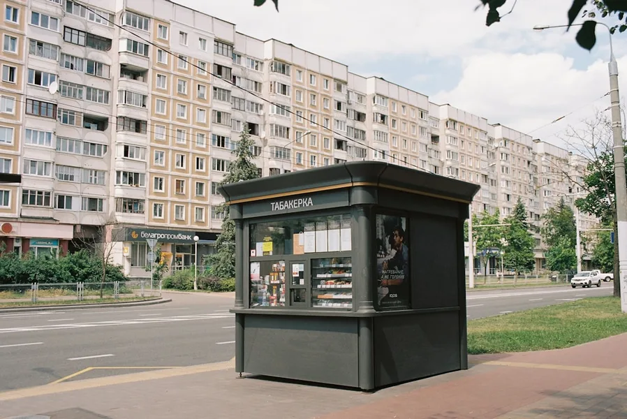 wheelchair user trying to reach street food stand Minsk Belarus inaccessible sidewalk