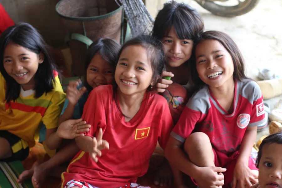 mother and schoolchildren online learning laptop Vietnam