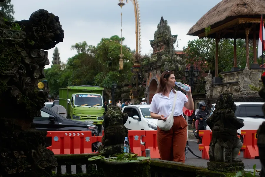 tourist inspecting car damage Bali