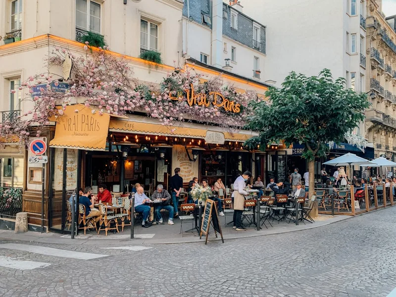 group students paying bill Paris cafe budget travel