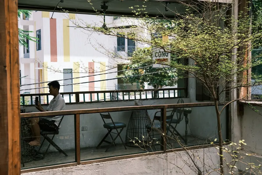 remote worker using laptop in Danang coworking space with large windows and plants