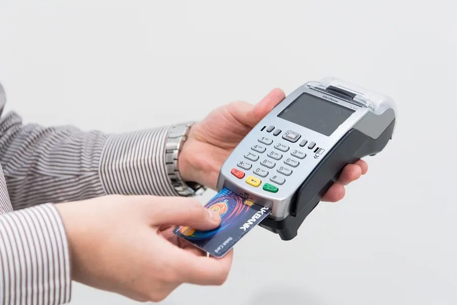 tourist using credit card at payment terminal in Dubai UAE Kotor Montenegro