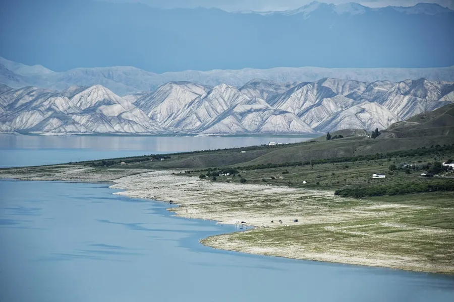 senior tourist uses crypto card Antalya nature park 2026 Osh Kyrgyzstan