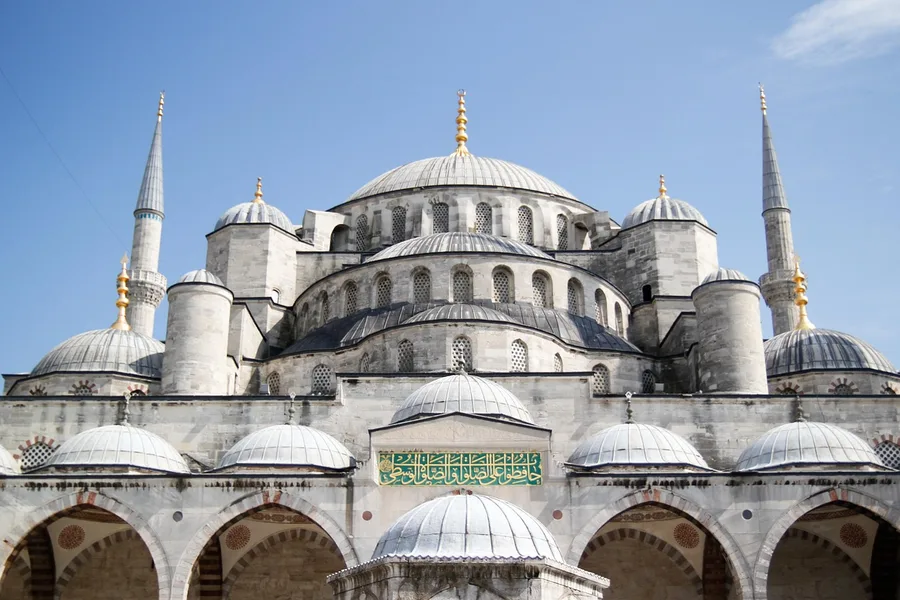 tourists wearing headscarves entering Sultanahmet Mosque Istanbul Turkey Osh Kyrgyzstan