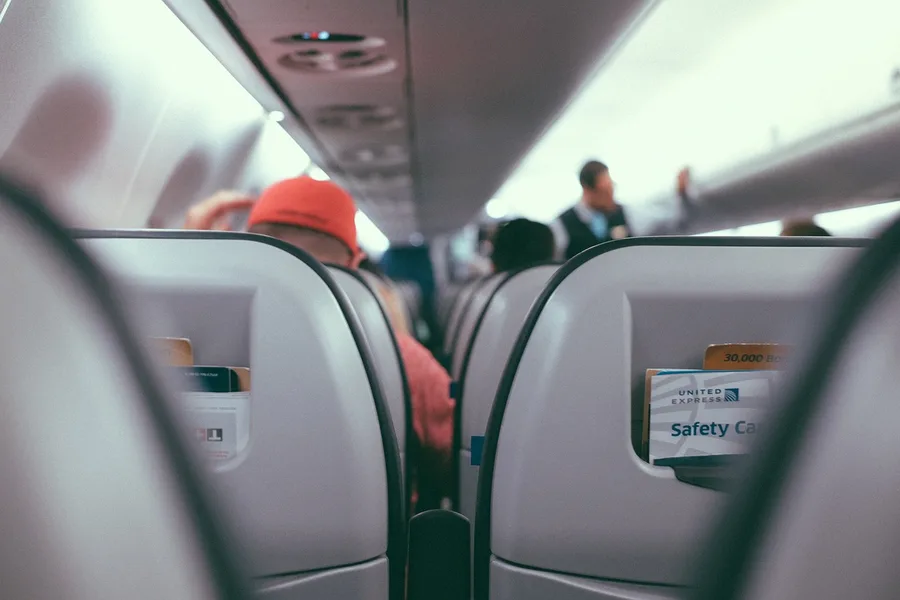 FlyArystan airplane cabin interior luggage overhead bin Kemer Turkey