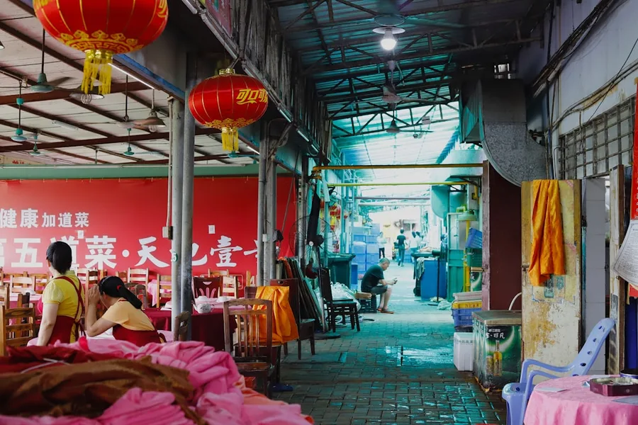 Guangzhou bustling street food market with local vendors China