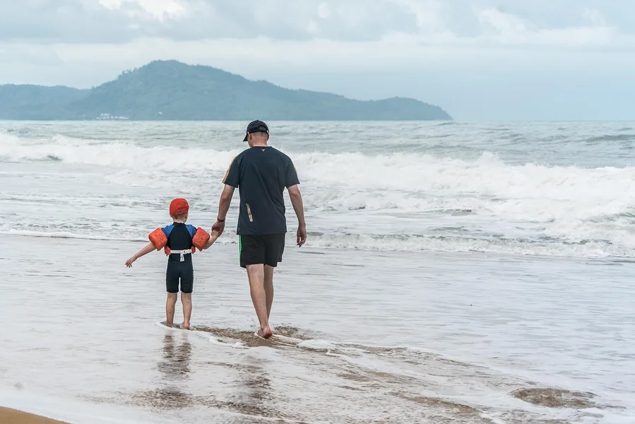 Family with toddler on Nai Harn Beach Phuket Thailand