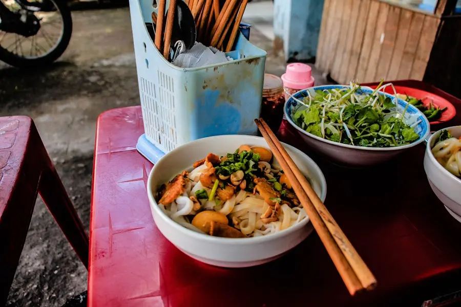 Vietnamese street food market stall with fresh seafood and tropical fruits in Danang