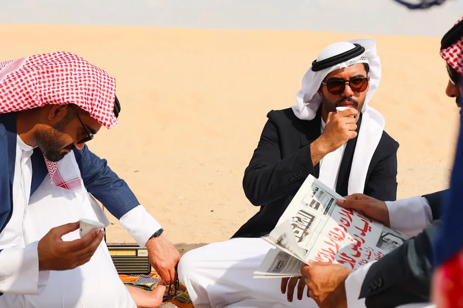 senior traveler paying cash at airline ticket office Dubai UAE